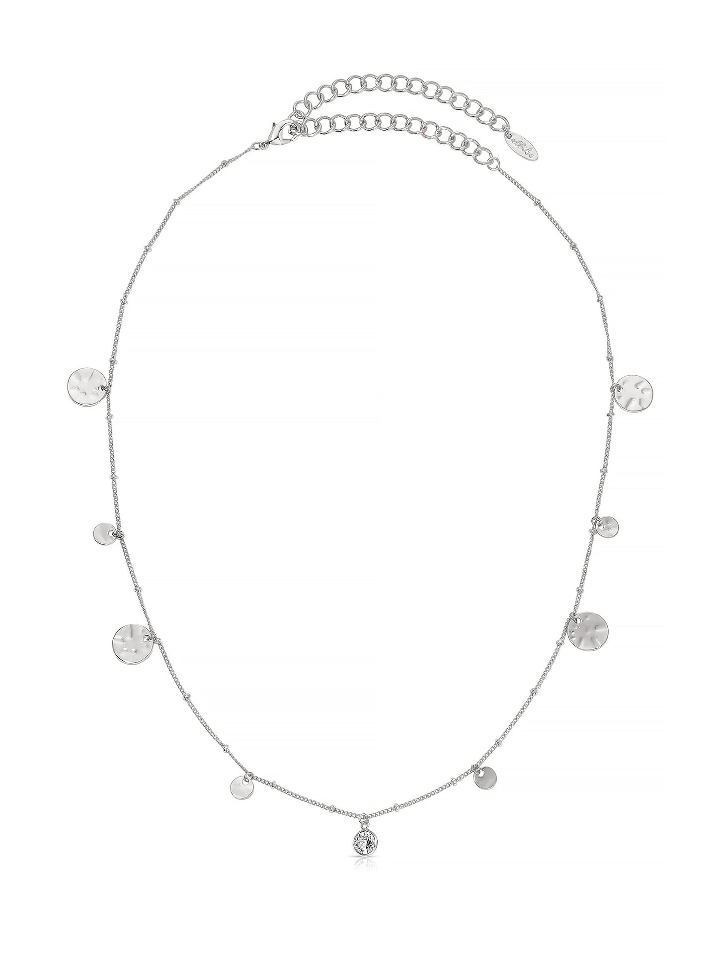 A silver necklace features small, round pendants of varying sizes along a delicate chain, with a central gem, placed against a light background.