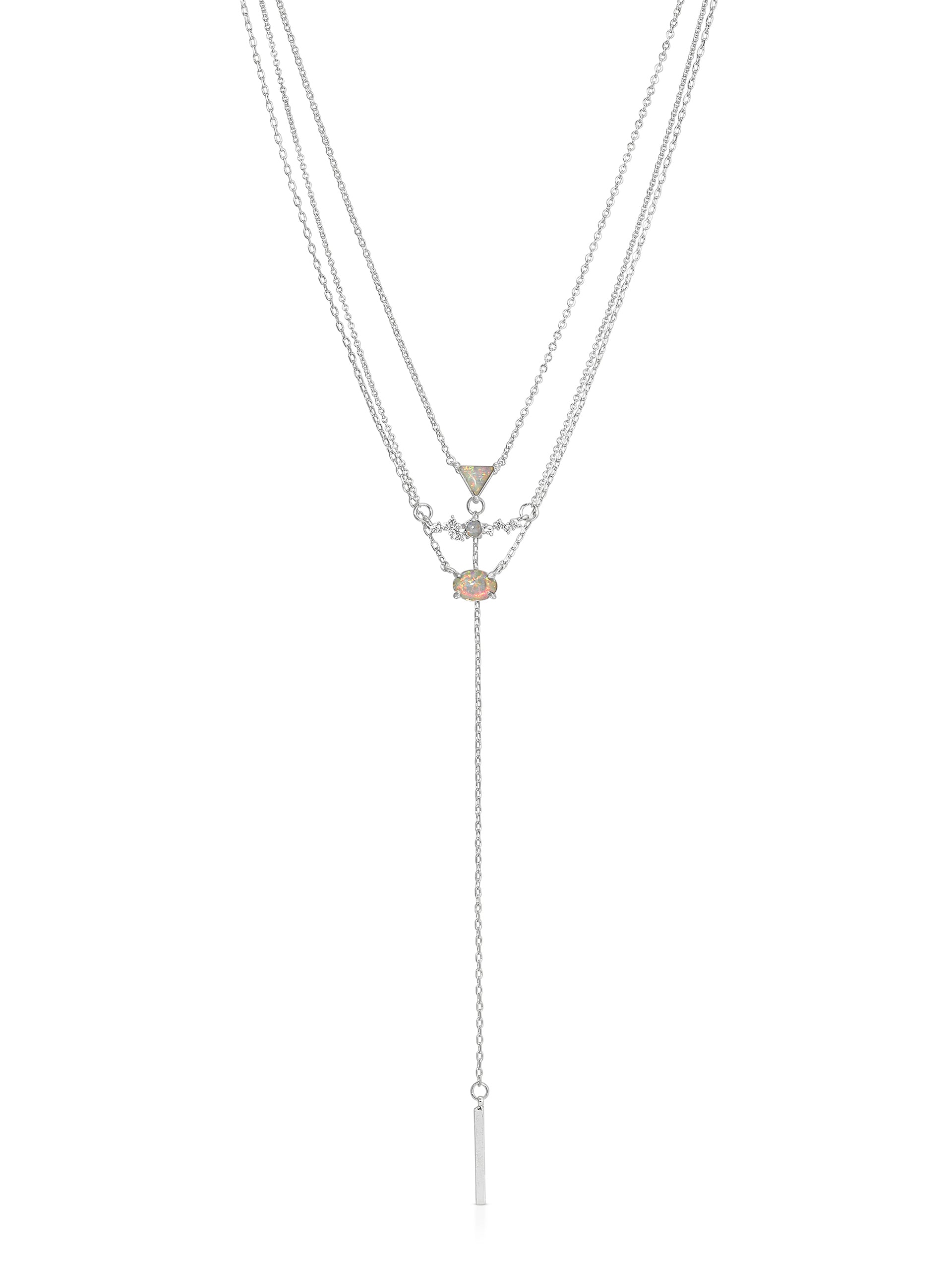 A layered silver necklace features a central colored gemstone and geometric pendants, with a long, delicate chain ending in a thin bar, displayed against a plain white background.