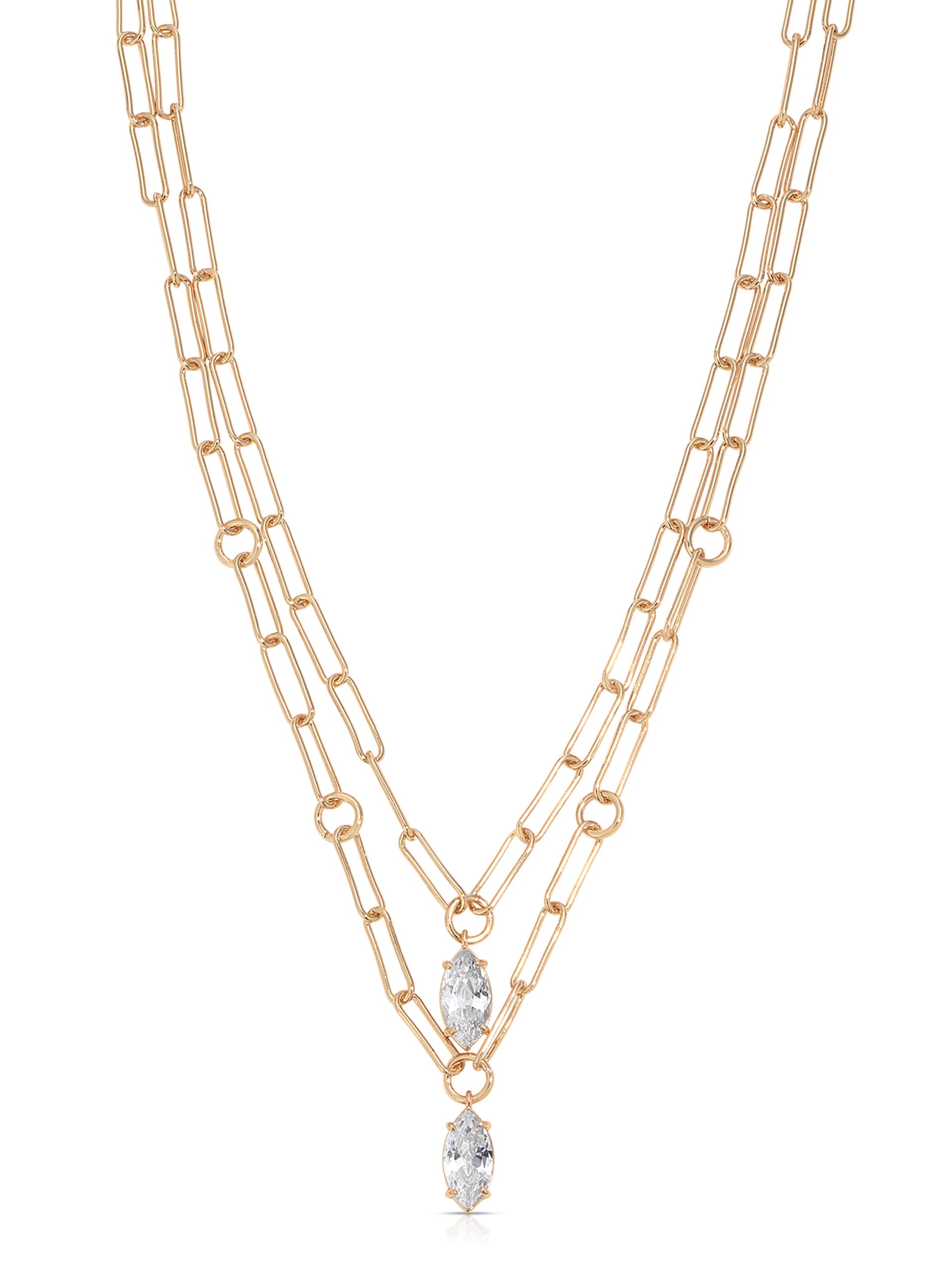 A gold chain necklace features two layered strands with elongated links. At the center, two marquise-cut crystals dangle, enhancing the jewelry's elegance against a neutral background.